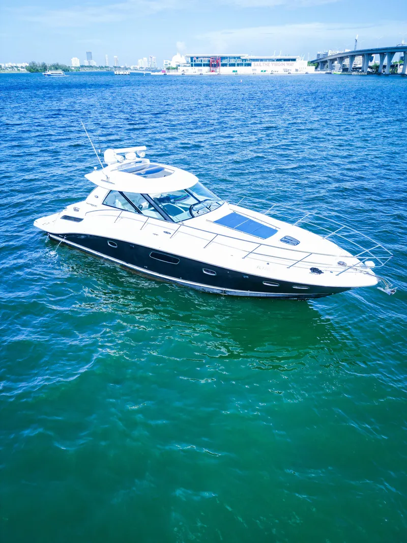Slide: The Image of 2010 Sea Ray 450 Sundancer yacht cruising on open water. - 5