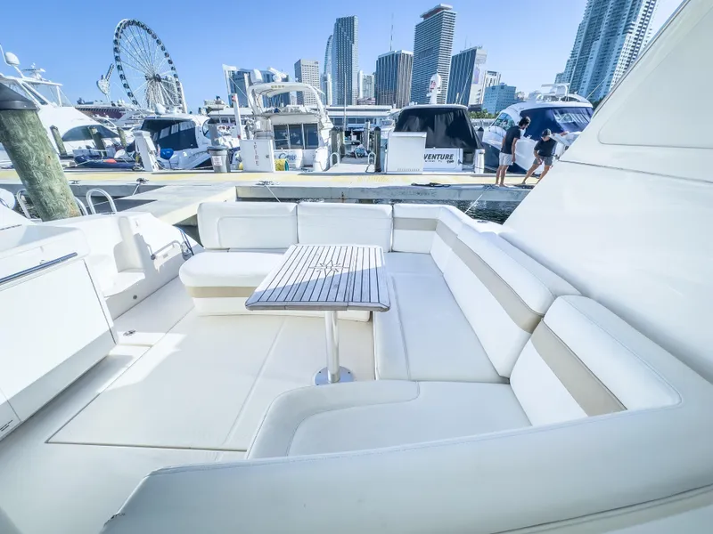 Slide: The Image of 2010 Sea Ray 450 Sundancer yacht with spacious seating area docked at marina. - 6