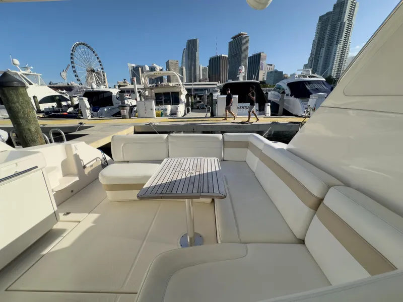 Slide: The Image of 2010 Sea Ray 450 Sundancer yacht docked with city skyline and Ferris wheel in background. - 7