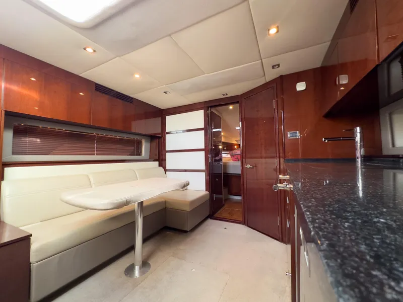 Slide: The Image of Interior of 2010 Sea Ray 450 Sundancer yacht with modern seating and kitchen area. - 9