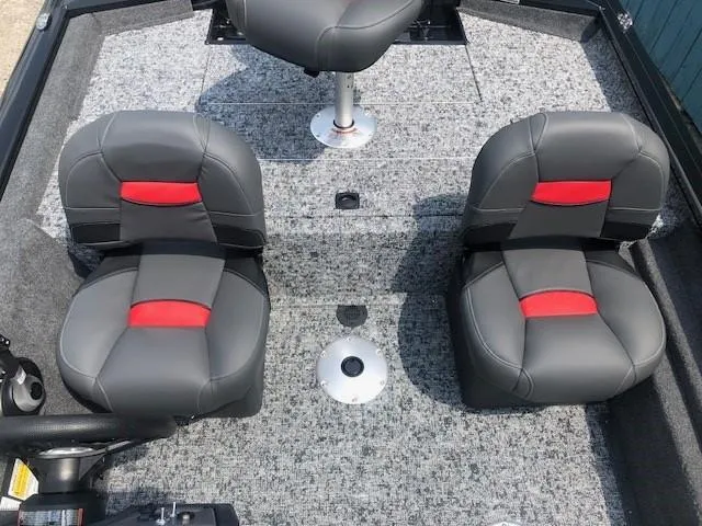 Slide: The Image of 2025 Tracker Pro Team 175 Crappie Edition boat interior with gray and red seats. - 14