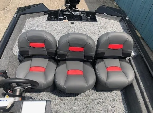 Slide: The Image of 2025 Tracker Pro Team 175 Crappie Edition boat interior with four gray and red seats. - 15