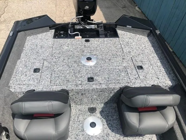 Slide: The Image of 2025 Tracker Pro Team 175 Crappie Edition boat interior with two seats and storage compartments. - 21