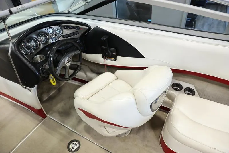 Slide: The Image of 2007 Crownline 23 SS boat interior with white and red seating, steering wheel, and dashboard. - 12