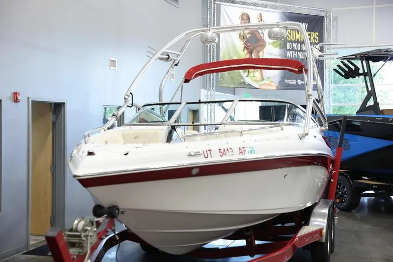 Slide: The Image of 2007 Crownline 23 SS boat on a red trailer in a showroom. - 8