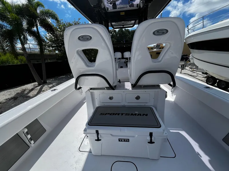 Slide: The Image of 2024 Sportsman Masters 267 Bay Boat interior with dual seats and Yeti cooler. - 13
