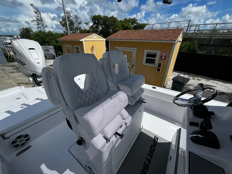 Slide: The Image of 2024 Sportsman Masters 267 Bay Boat with dual captain's chairs and steering console. - 14