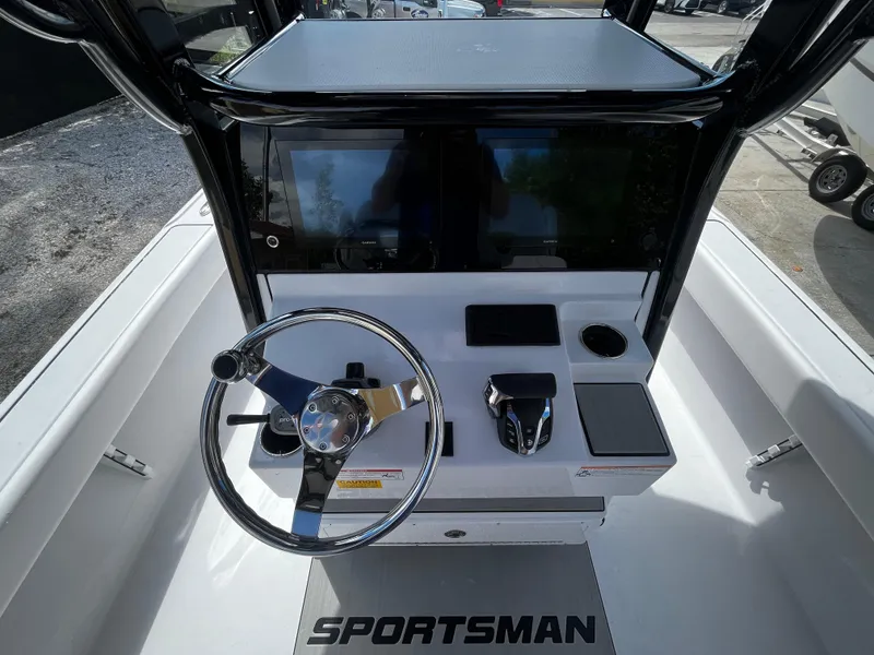 Slide: The Image of 2024 Sportsman Masters 267 Bay Boat console with steering wheel and controls. - 19