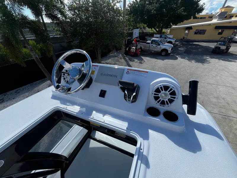 Slide: The Image of 2024 Sportsman Masters 267 Bay Boat helm with Garmin electronics and steering wheel. - 21