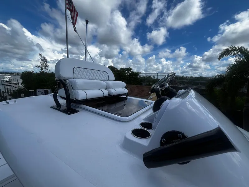 Slide: The Image of 2024 Sportsman Masters 267 Bay Boat helm station with seating and steering wheel. - 23