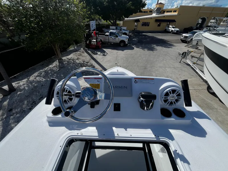 Slide: The Image of 2024 Sportsman Masters 267 Bay Boat helm with steering wheel and Garmin electronics. - 24