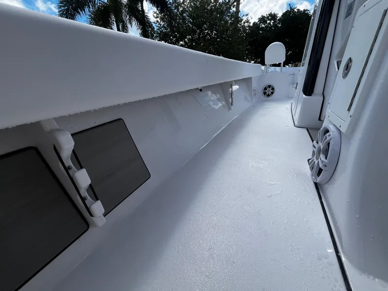 Slide: The Image of 2024 Sportsman Masters 267 Bay Boat interior deck view with storage compartments. - 25
