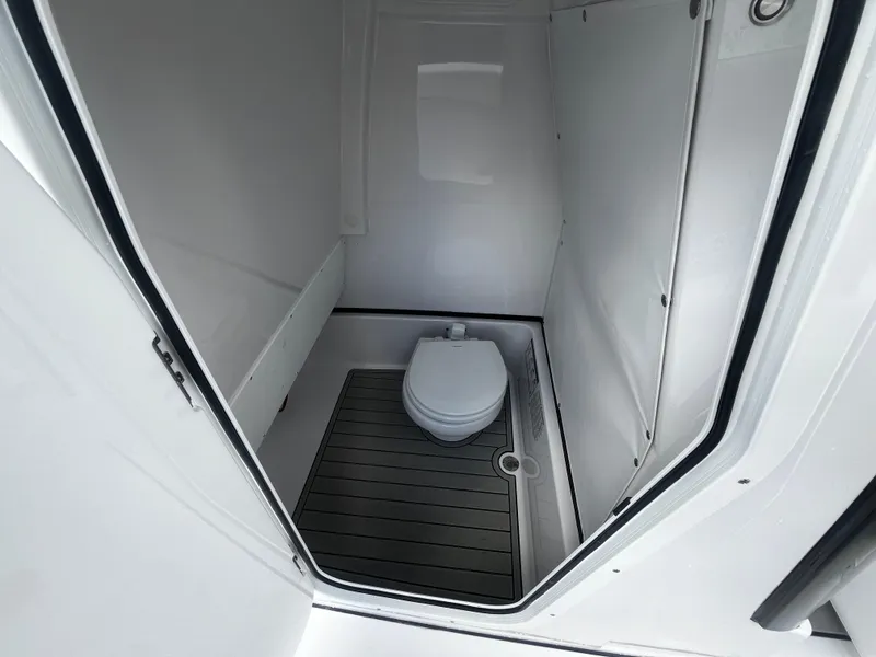 Slide: The Image of 2024 Sportsman Masters 267 Bay Boat interior bathroom with toilet. - 28