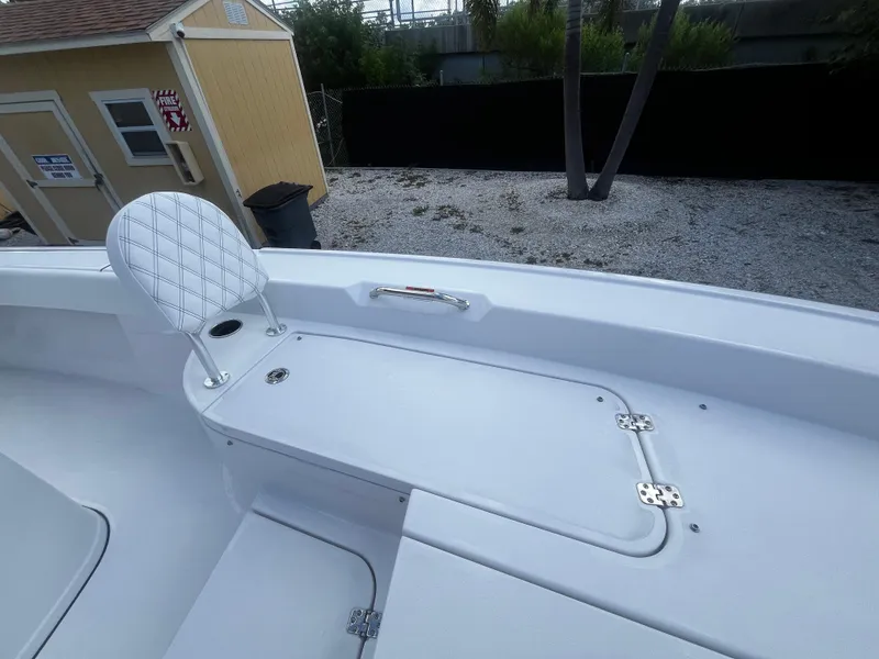 Slide: The Image of 2024 Sportsman Masters 267 Bay Boat interior seating and storage compartment. - 31