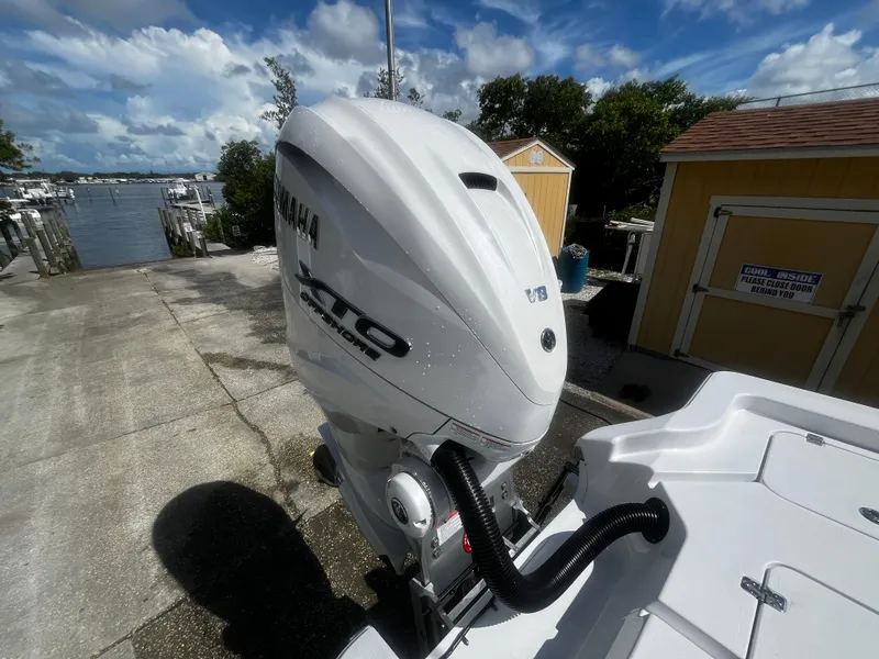 Slide: The Image of 2024 Sportsman Masters 267 Bay Boat with Yamaha outboard motor at dock. - 8