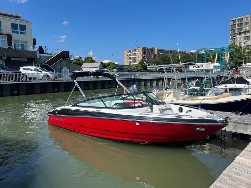 The Image of 2015 Monterey 204FS boat docked in a marina on a sunny day. - 0