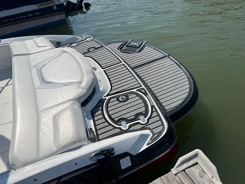 Slide: The Image of 2015 Monterey 204FS boat with swim platform docked on water. - 5