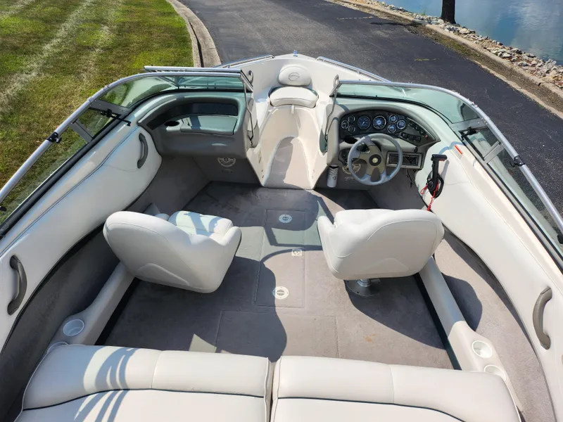 Slide: The Image of 2000 Crownline 192 BR boat interior with white seating and dashboard. - 10