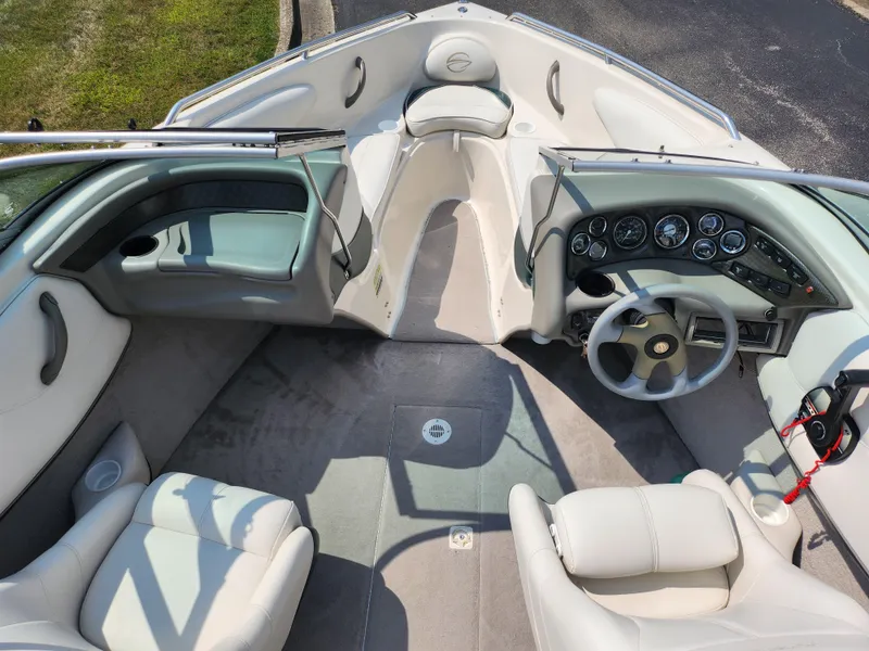 Slide: The Image of Interior of a 2000 Crownline 192 BR boat with seating and dashboard. - 11