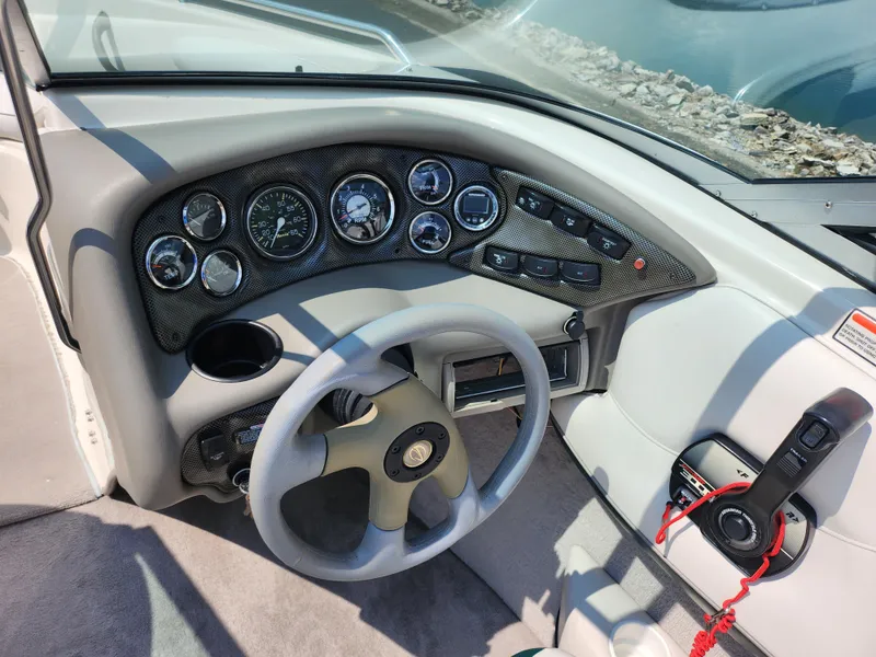 Slide: The Image of 2000 Crownline 192 BR boat dashboard with steering wheel and control panel. - 13