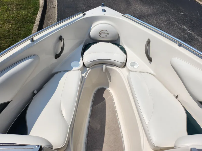 Slide: The Image of 2000 Crownline 192 BR boat interior with white cushioned seating. - 16