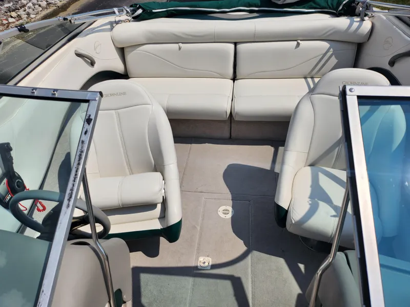 Slide: The Image of 2000 Crownline 192 BR boat interior with white leather seats and open windshield. - 19