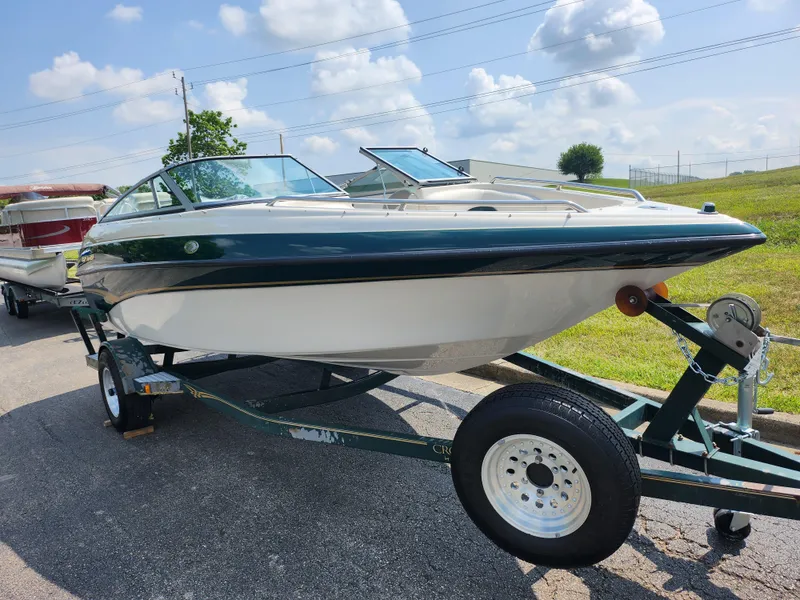 Slide: The Image of 2000 Crownline 192 BR boat on trailer under sunny sky. - 5