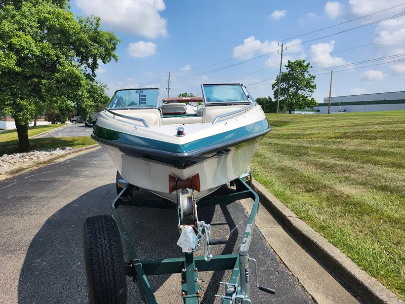 Slide: The Image of 2000 Crownline 192 BR boat on trailer, parked on a sunny day. - 6