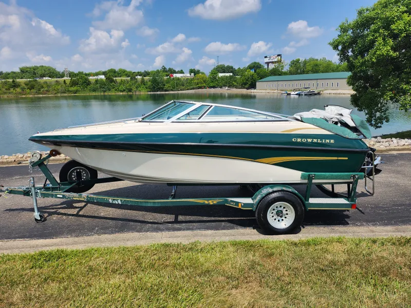 Slide: The Image of 2000 Crownline 192 BR boat on a trailer by a lake. - 9