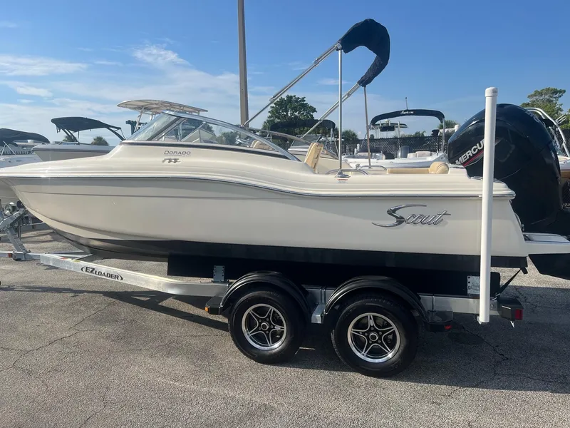 Slide: The Image of 2021 Scout 210 Dorado boat on trailer, side view, in a marina. - 2