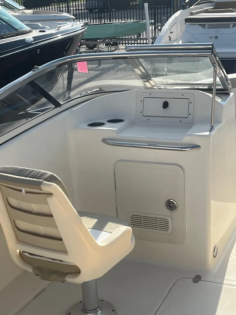 Slide: The Image of 2021 Scout 210 Dorado boat interior with helm station and captain's chair. - 5