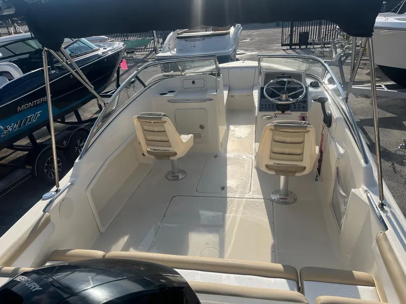 Slide: The Image of 2021 Scout 210 Dorado boat interior with dual seats and steering console. - 7