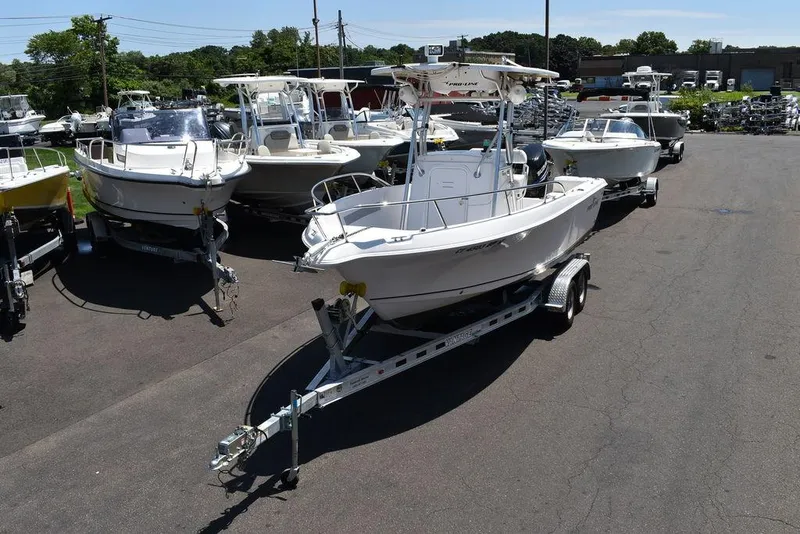 Slide: The Image of 2006 Pro-Line 21 Sport Center Console boat on a trailer in a dealership lot. - 2