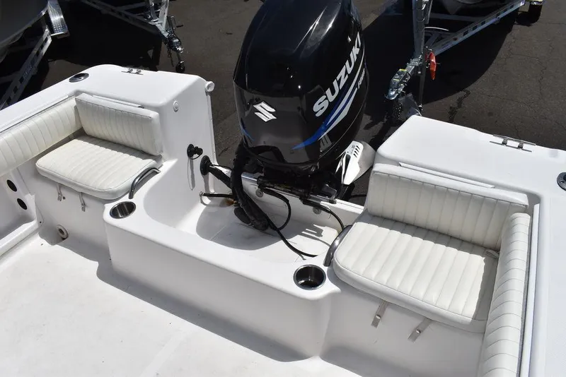 Slide: The Image of 2006 Pro-Line 21 Sport Center Console boat with Suzuki outboard motor and white seating. - 26