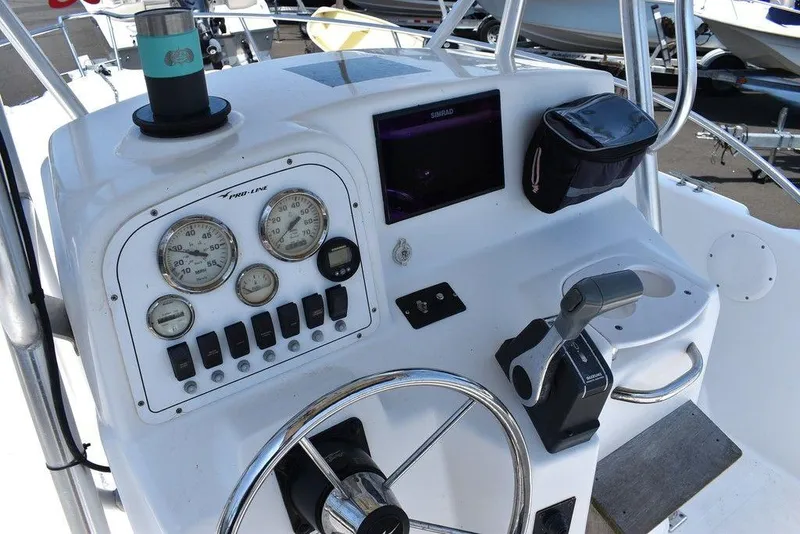 Slide: The Image of 2006 Pro-Line 21 Sport Center Console boat dashboard with gauges and controls. - 35