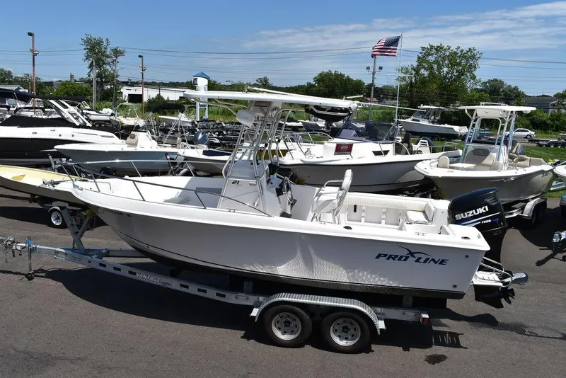 Slide: The Image of 2006 Pro-Line 21 Sport Center Console boat on a trailer in a marina. - 5
