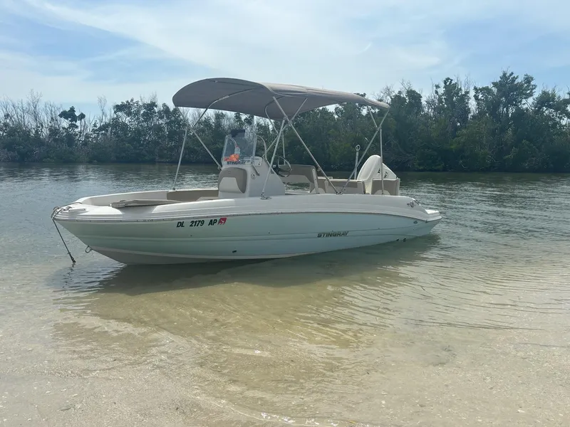 Slide: The Image of 2019 Stingray 186CC boat anchored in shallow water with canopy. - 5
