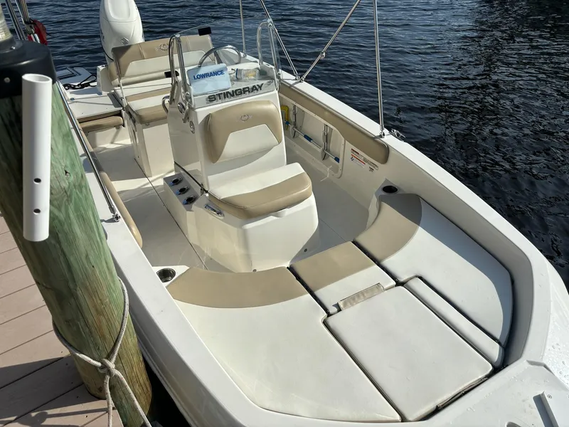 Slide: The Image of 2019 Stingray 186CC boat docked, featuring beige and white seating. - 8