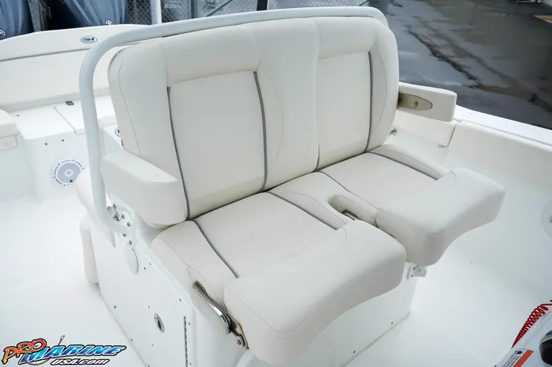 Slide: The Image of 2023 Sea Hunt Ultra 275 SE boat with white cushioned seating. - 14