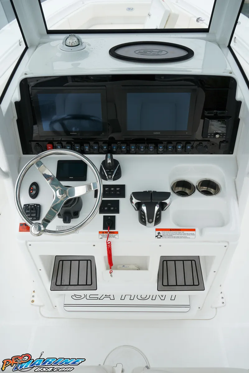 Slide: The Image of 2023 Sea Hunt Ultra 275 SE boat dashboard with steering wheel and control panel. - 17