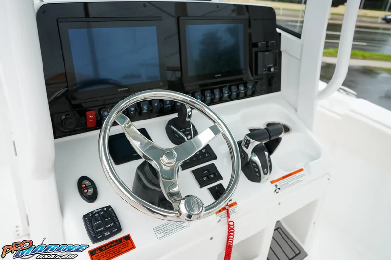 Slide: The Image of 2023 Sea Hunt Ultra 275 SE boat dashboard with dual screens and steering wheel. - 18