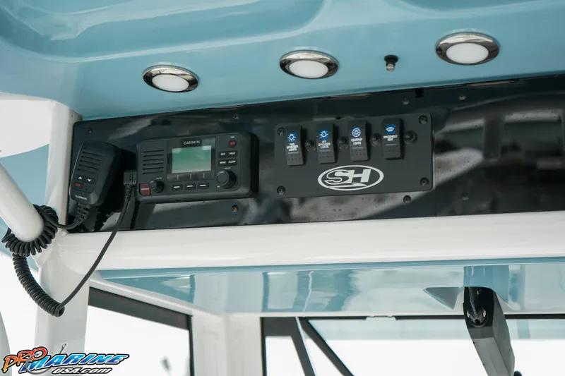 Slide: The Image of 2023 Sea Hunt Ultra 275 SE control panel with Garmin radio and switches. - 20