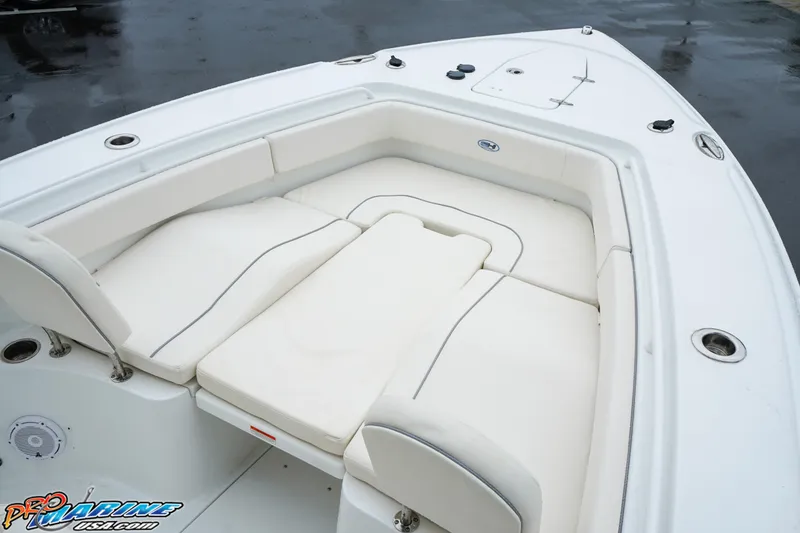 Slide: The Image of 2023 Sea Hunt Ultra 275 SE boat with spacious white cushioned seating area. - 23