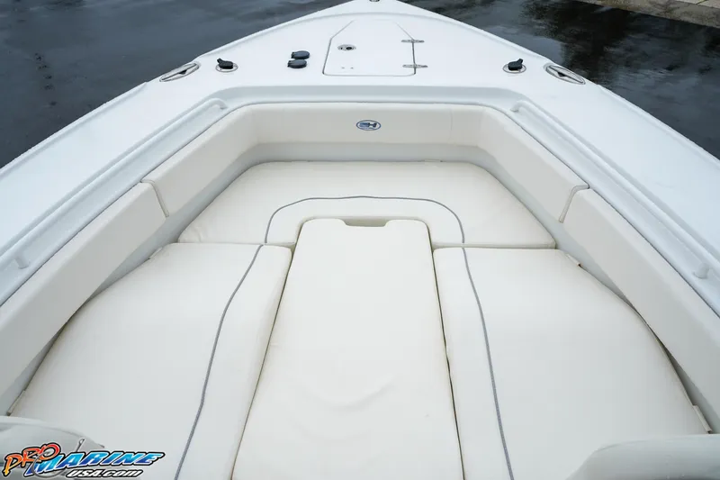 Slide: The Image of 2023 Sea Hunt Ultra 275 SE boat bow seating area with white cushions. - 24