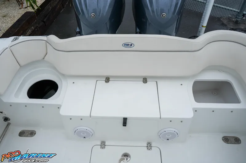 Slide: The Image of 2023 Sea Hunt Ultra 275 SE boat stern with storage compartments and twin engines. - 9