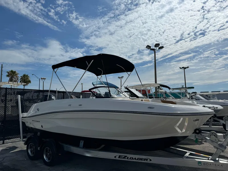 The Image of 2021 Bayliner VR5 Bowrider OB on trailer under a partly cloudy sky. - 0