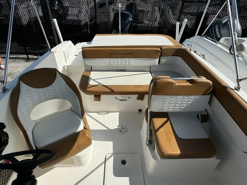 Slide: The Image of 2021 Bayliner VR5 Bowrider OB interior with tan and white seating. - 5