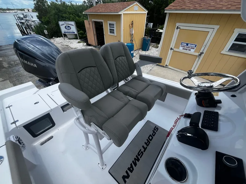 Slide: The Image of 2025 Sportsman Masters 227 Bay Boat interior with dual seats and Yamaha engine. - 12