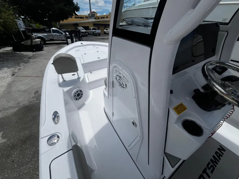 Slide: The Image of 2025 Sportsman Masters 227 Bay Boat, white interior, docked, close-up view. - 16