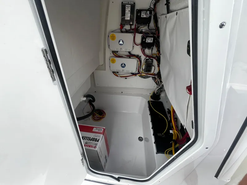 Slide: The Image of 2025 Sportsman Masters 227 Bay Boat electrical compartment with batteries and wiring. - 17